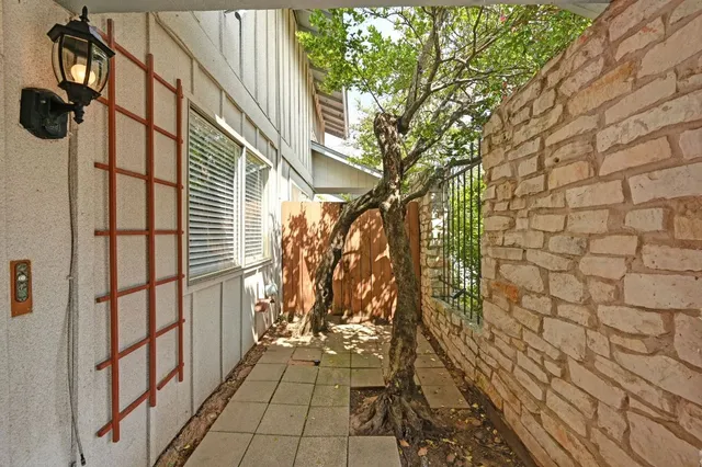 a path view of a house with a tree