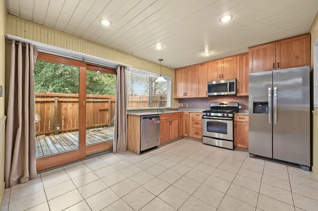 a kitchen with stainless steel appliances a refrigerator sink and microwave