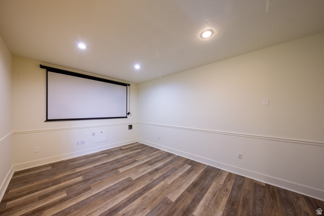 868 Braddock Lane Alpine, UT 84004 - Photo 43 of 64 Spacious room featuring a retractable projection screen, recessed lighting, wood-finish flooring, and two-tone walls with chair rail molding