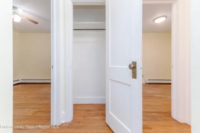 a view of empty room with wooden floor