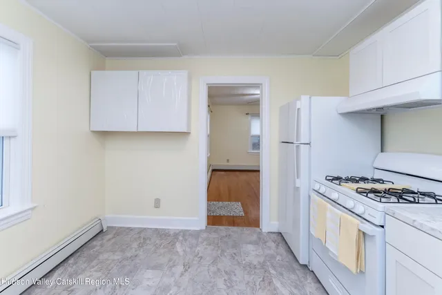 a kitchen with a sink cabinets and window