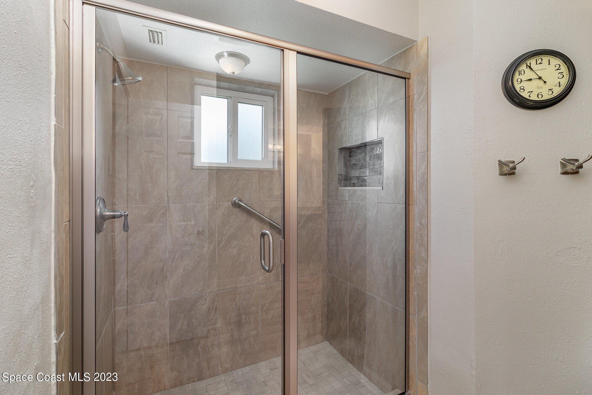 833 Pine Shadows Avenue Rockledge, FL 32955 - Photo 11 of 24 a bathroom with a glass shower door