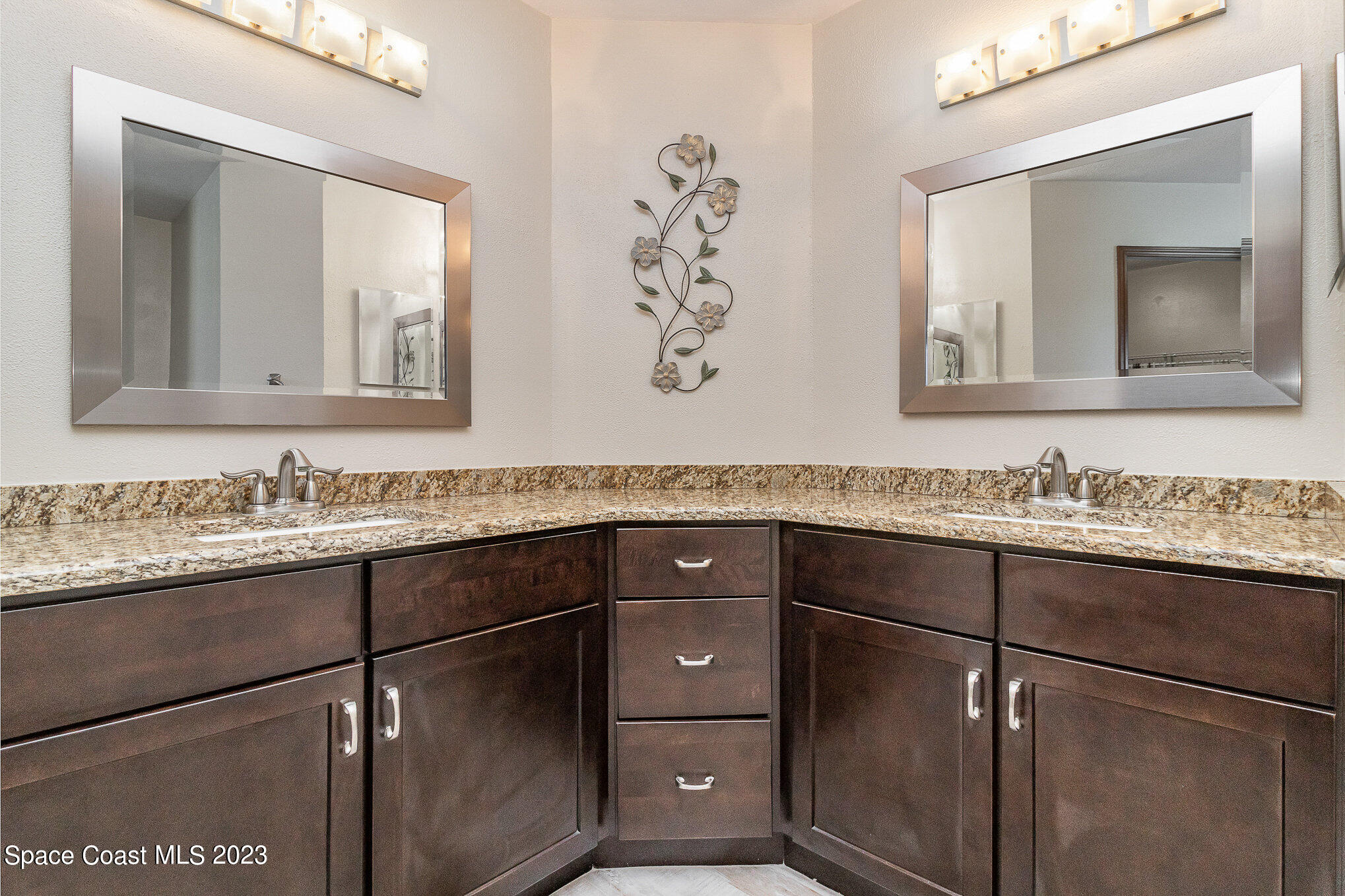 833 Pine Shadows Avenue Rockledge, FL 32955 - Photo 12 of 24 a bathroom with a granite countertop sink vanity and mirror