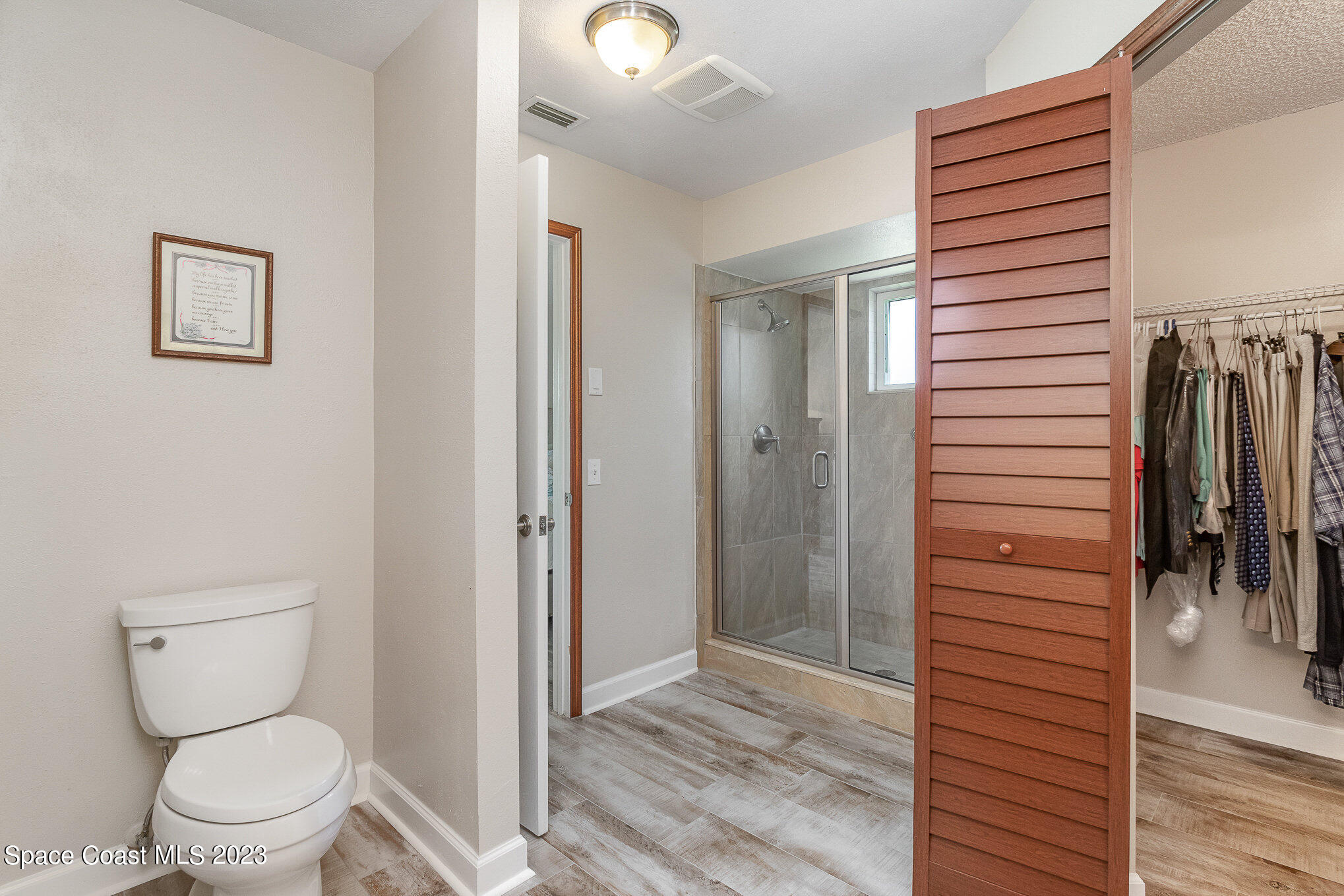 833 Pine Shadows Avenue Rockledge, FL 32955 - Photo 13 of 24 a bathroom with a toilet and a shower
