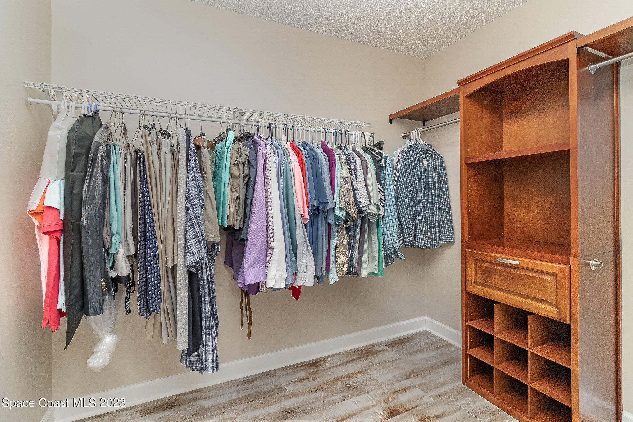 833 Pine Shadows Avenue Rockledge, FL 32955 - Photo 14 of 24 a view of walk in closet with clothes and shoes