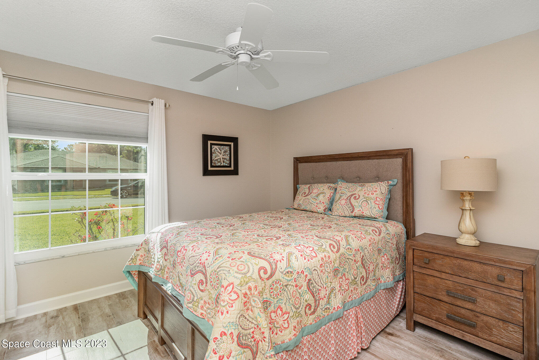 833 Pine Shadows Avenue Rockledge, FL 32955 - Photo 15 of 24 a bedroom with a large bed and a window