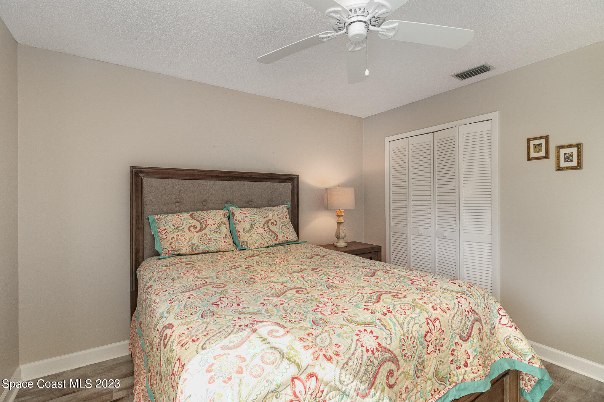 833 Pine Shadows Avenue Rockledge, FL 32955 - Photo 16 of 24 a bedroom with a large bed and a chandelier