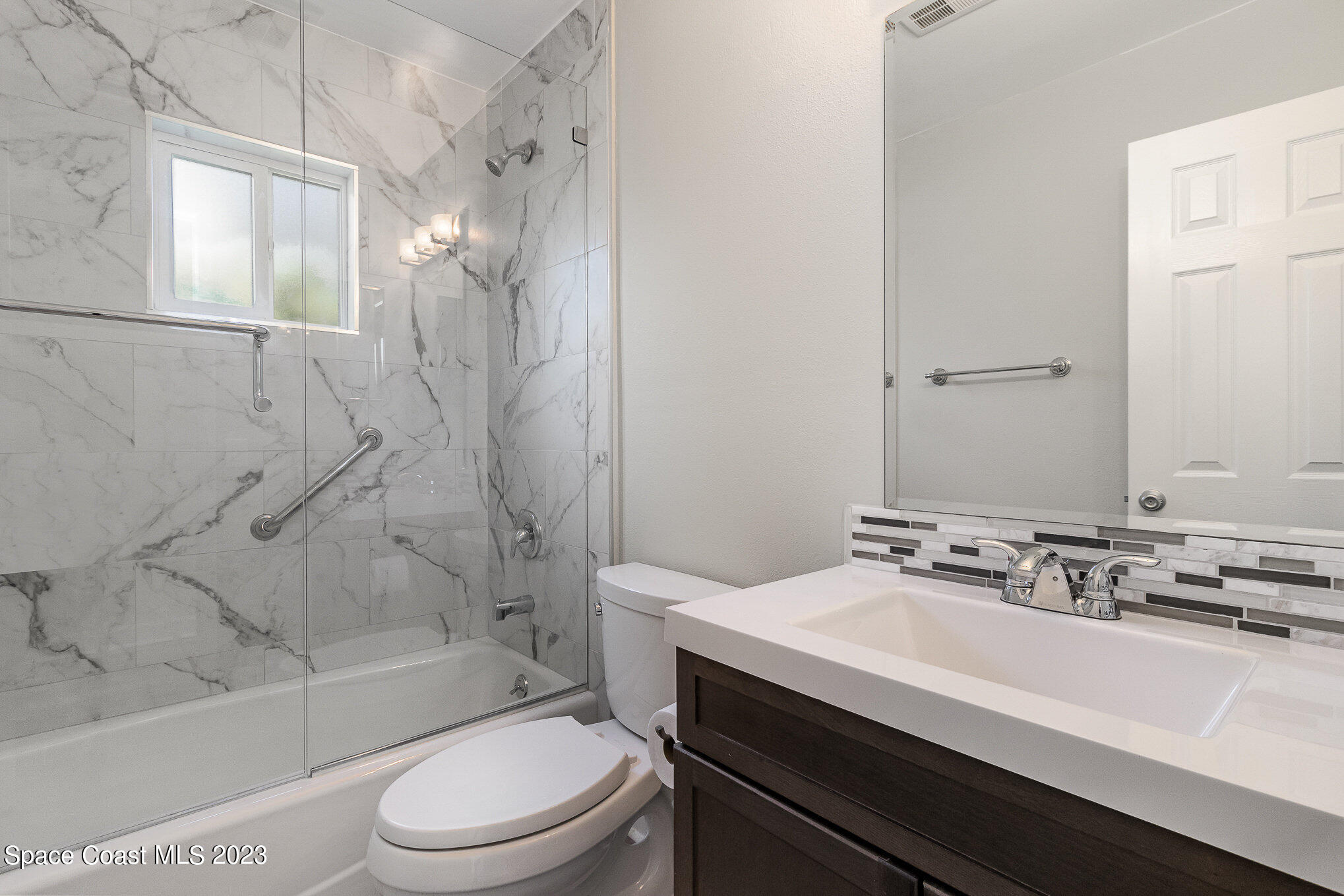 833 Pine Shadows Avenue Rockledge, FL 32955 - Photo 17 of 24 a bathroom with a sink a toilet and shower