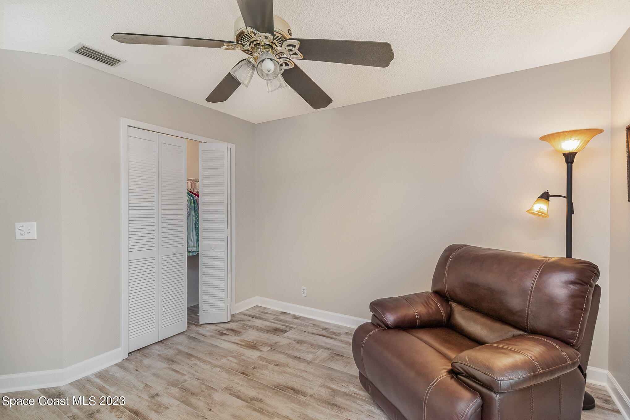 833 Pine Shadows Avenue Rockledge, FL 32955 - Photo 19 of 24 a room with furniture and a ceiling fan