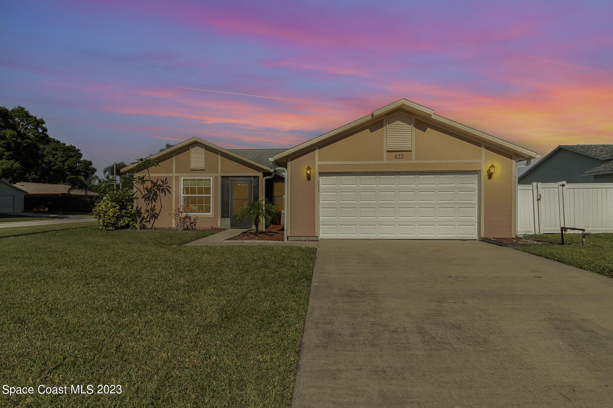 833 Pine Shadows Avenue Rockledge, FL 32955 - Photo 2 of 24 a front view of a house with a yard and garage