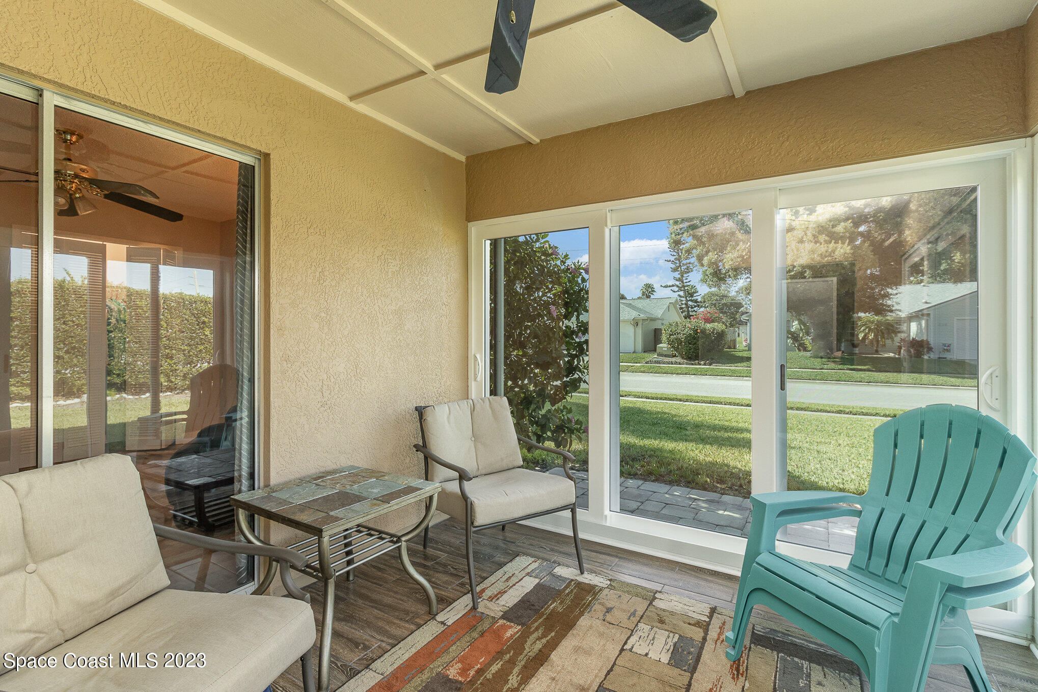 833 Pine Shadows Avenue Rockledge, FL 32955 - Photo 21 of 24 a living room with furniture and a floor to ceiling window
