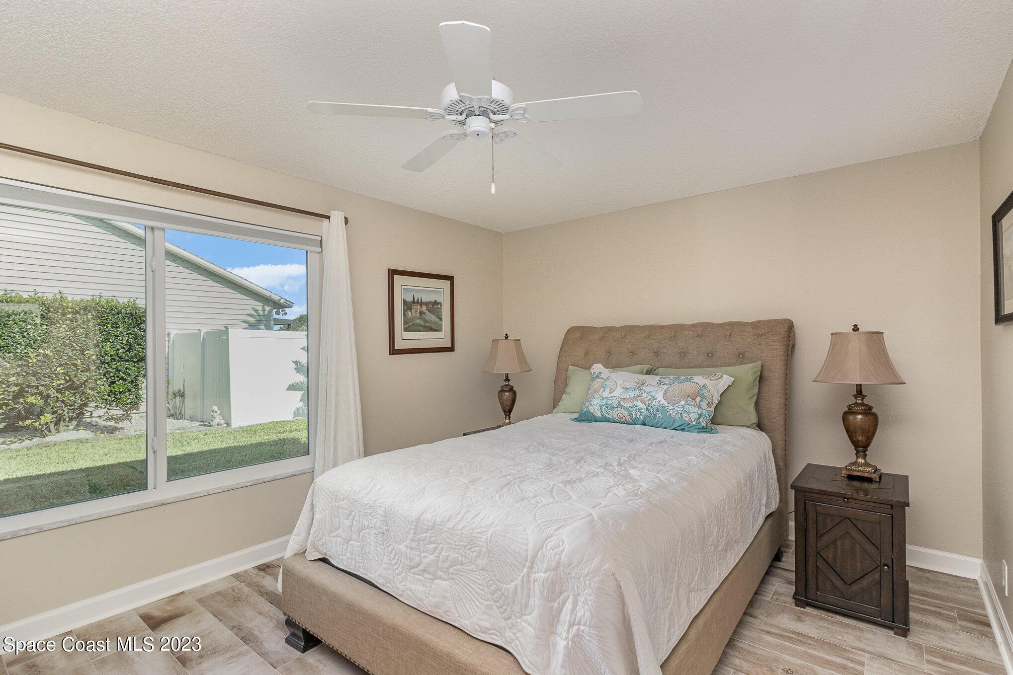 833 Pine Shadows Avenue Rockledge, FL 32955 - Photo 9 of 24 a bedroom with a large bed and a chandelier