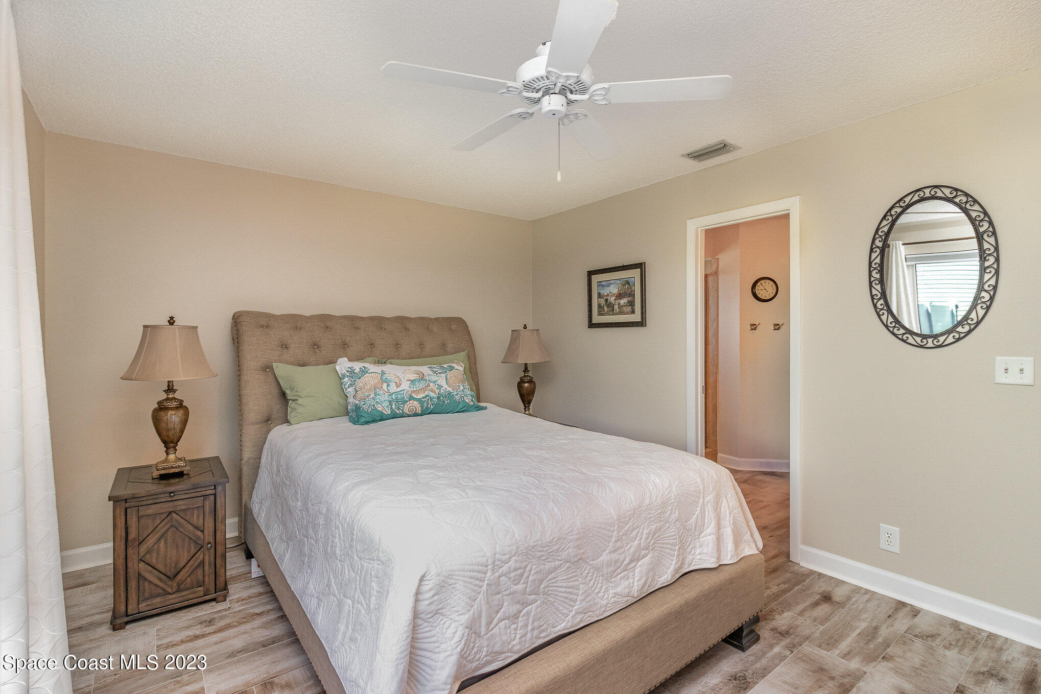 833 Pine Shadows Avenue Rockledge, FL 32955 - Photo 10 of 24 a bedroom with a bed and a chandelier