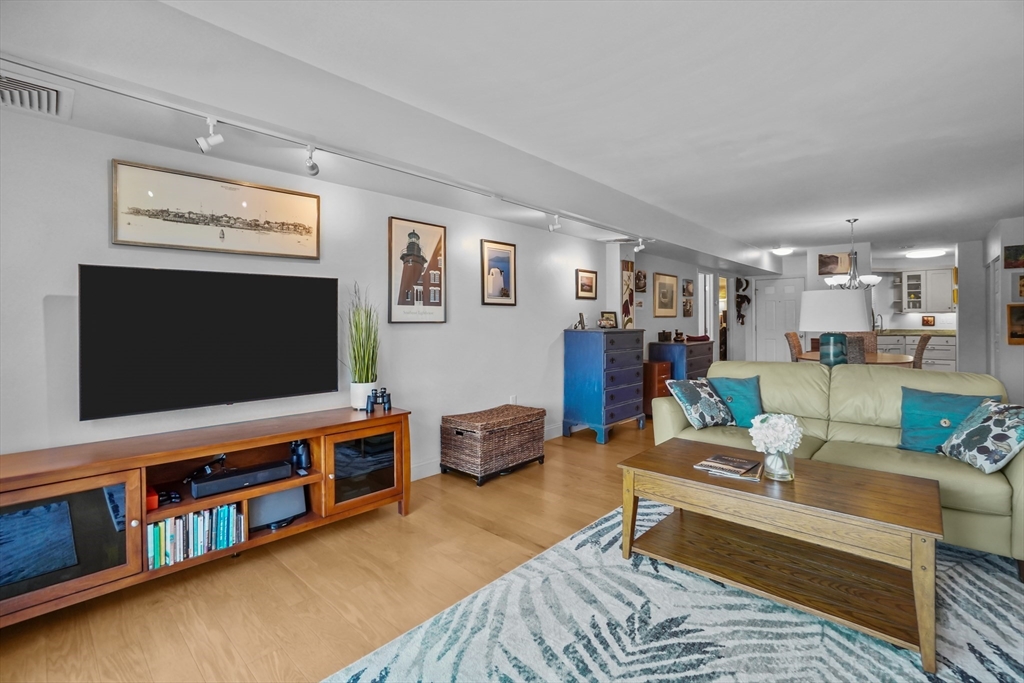 45 Main Street, Unit 112 Wareham, MA 02571 - Photo 3 of 30 a living room with furniture and a flat screen tv