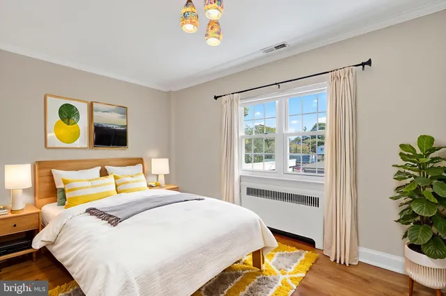 a bedroom with a bed and a potted plant