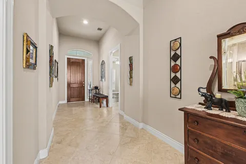 a view of a hallway with mirror and furniture