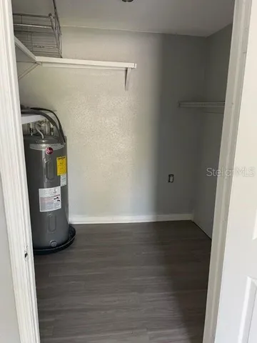 a view of walk in closet with wooden floor
