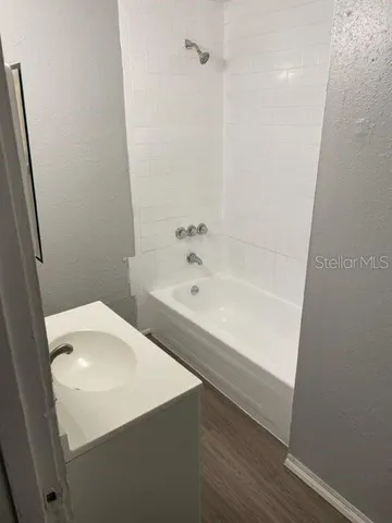 a bathroom with a bathtub and sink