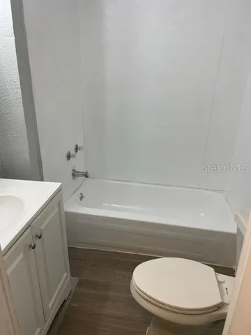 a bathroom with a toilet and a bathtub