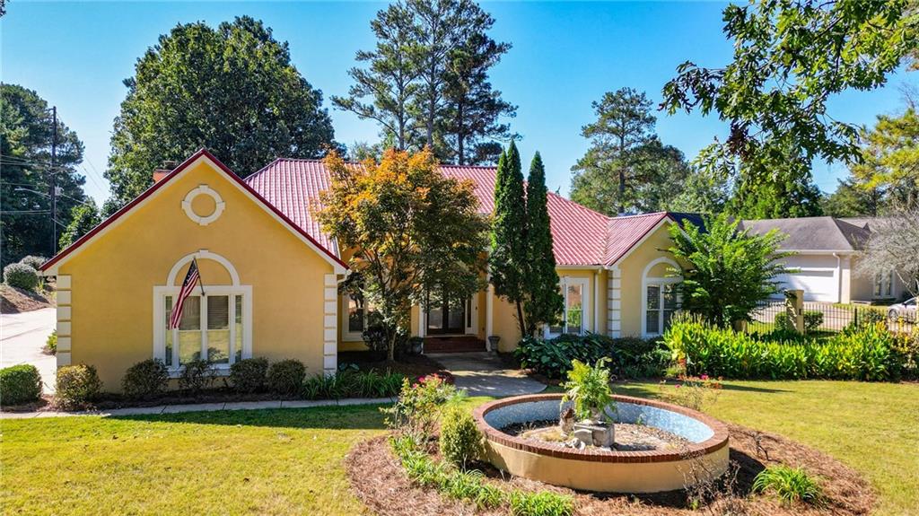 a view of a house with swimming pool and yard