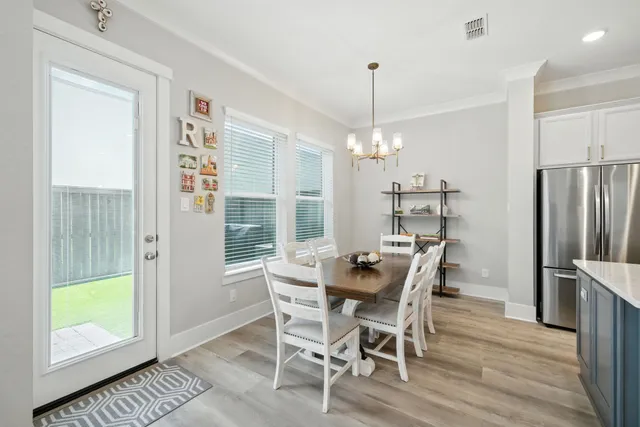 a kitchen with kitchen island a dining table and chairs