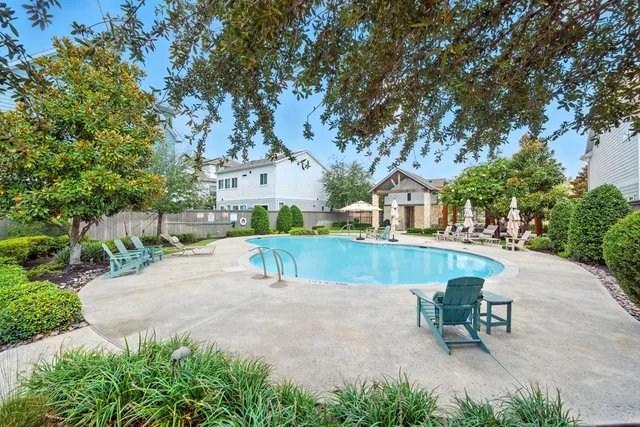 a spacious bedroom with a bed and a chandelier