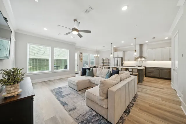 a living room with furniture and kitchen view