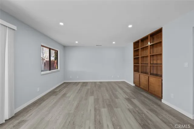 an empty room with wooden floor and closet