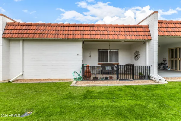 a backyard of a house with table and chairs
