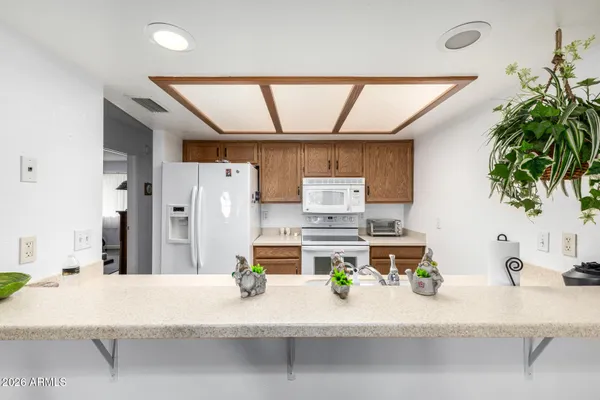 a bedroom with a bed table and a window