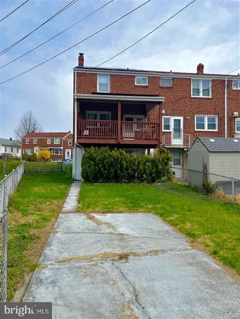 a view of a brick building next to a yard