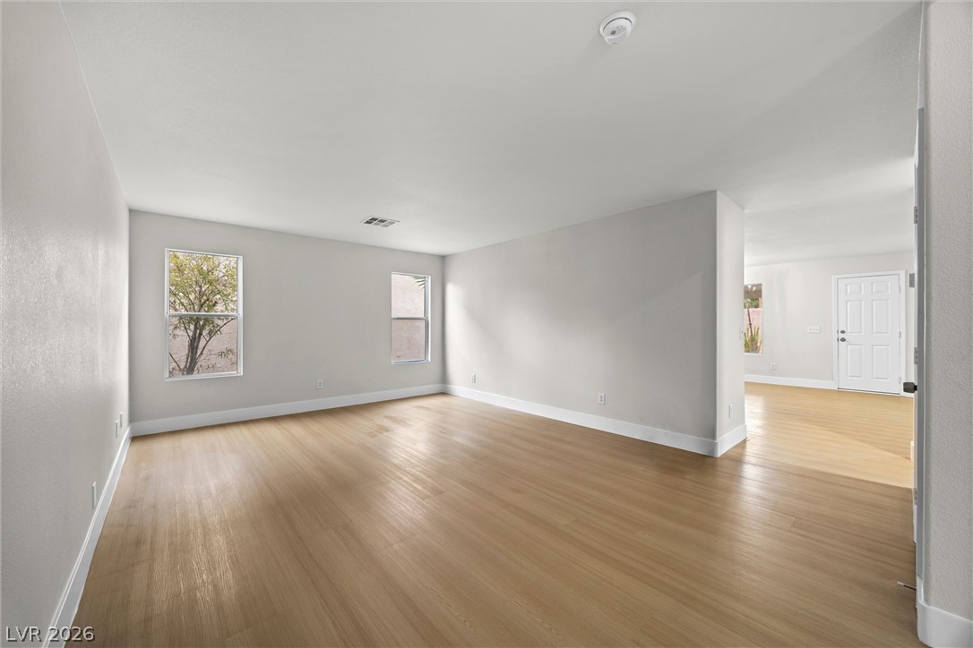 2650 Whisper Ridge Street Las Vegas, NV 89156 - Photo 8 of 28 Smooth wood-style flooring and neutral walls define this versatile, open living area.