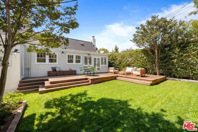 a view of a house with swimming pool and sitting area