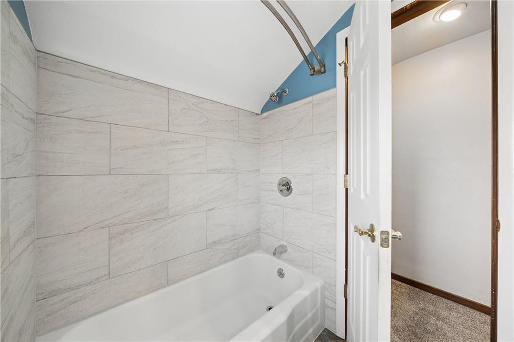 711 Jane Street Pittsburgh, PA 15239 - Photo 15 of 27 Crisp and well-maintained main bathroom equipped with modern fixtures and a classic tiled shower.