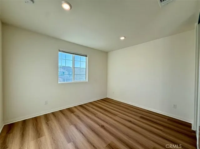 a view of a room with wooden floor and fan