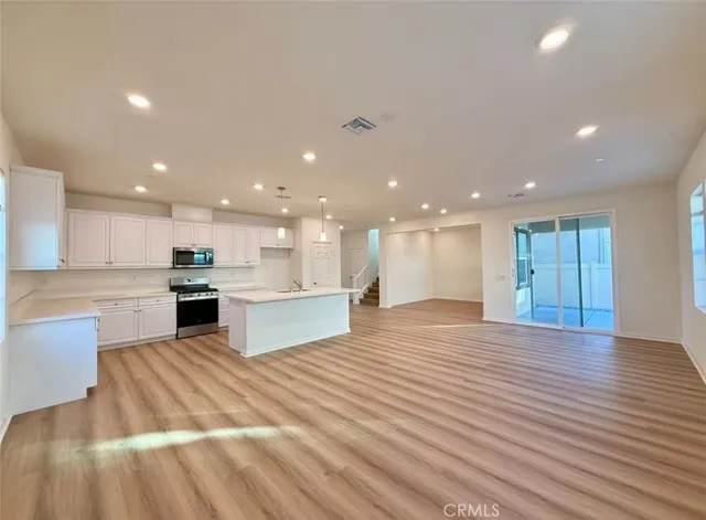 a view of kitchen with kitchen island sink and center island