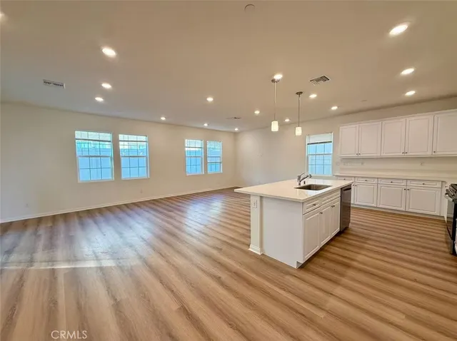 a large kitchen with stainless steel appliances granite countertop a large center island and a sink