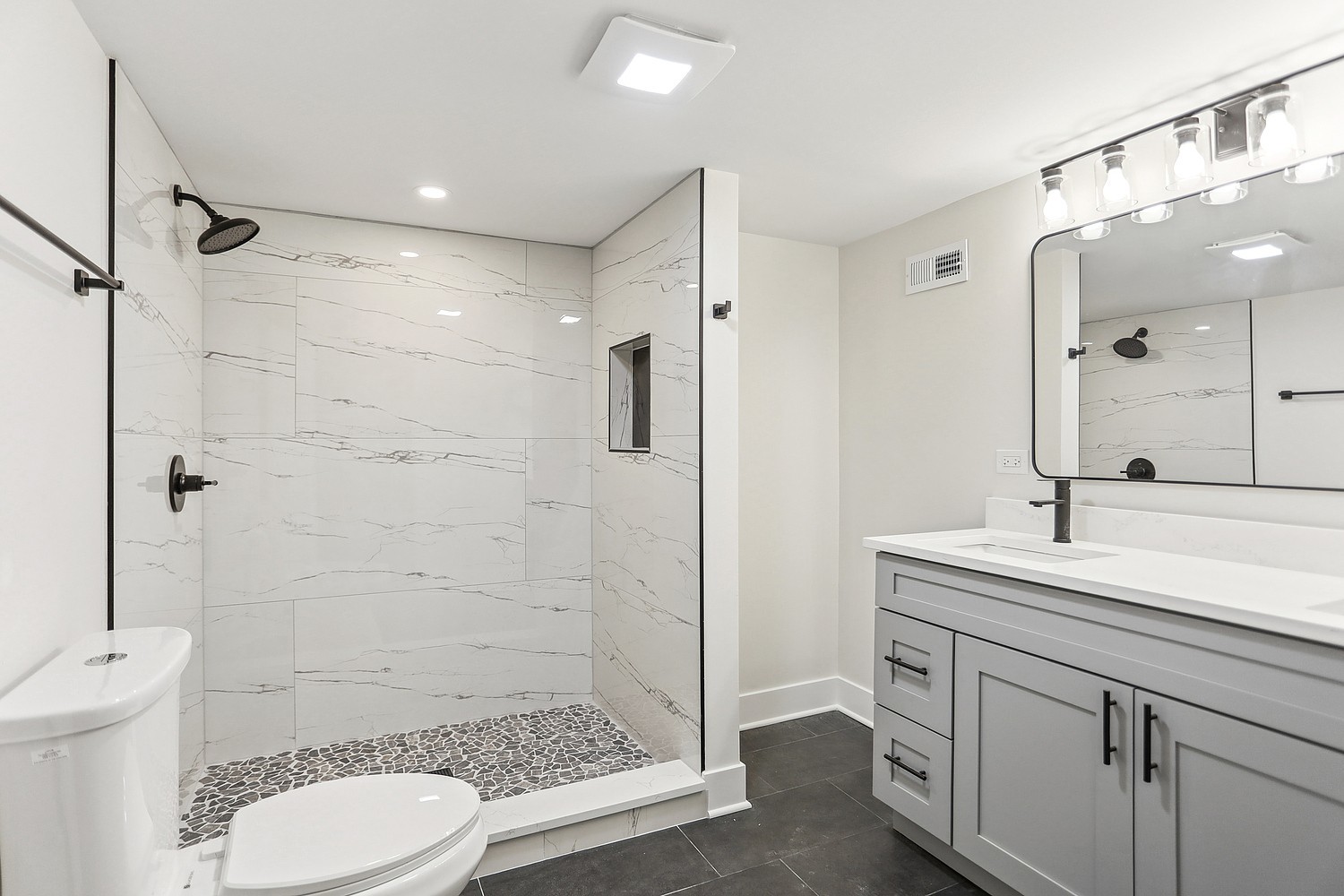 4832 West Harrison Street Chicago, IL 60644 - Photo 11 of 21 a bathroom with a sink a toilet a mirror and shower