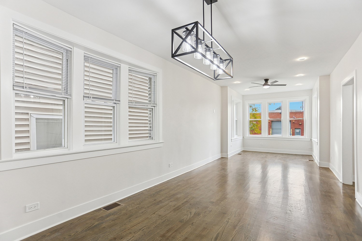 4832 West Harrison Street Chicago, IL 60644 - Photo 13 of 21 a view of an empty room with wooden floor and windows