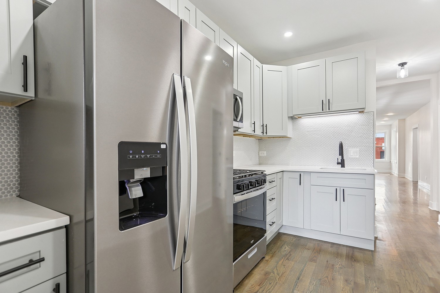 4832 West Harrison Street Chicago, IL 60644 - Photo 15 of 21 a kitchen with stainless steel appliances a refrigerator stove and sink