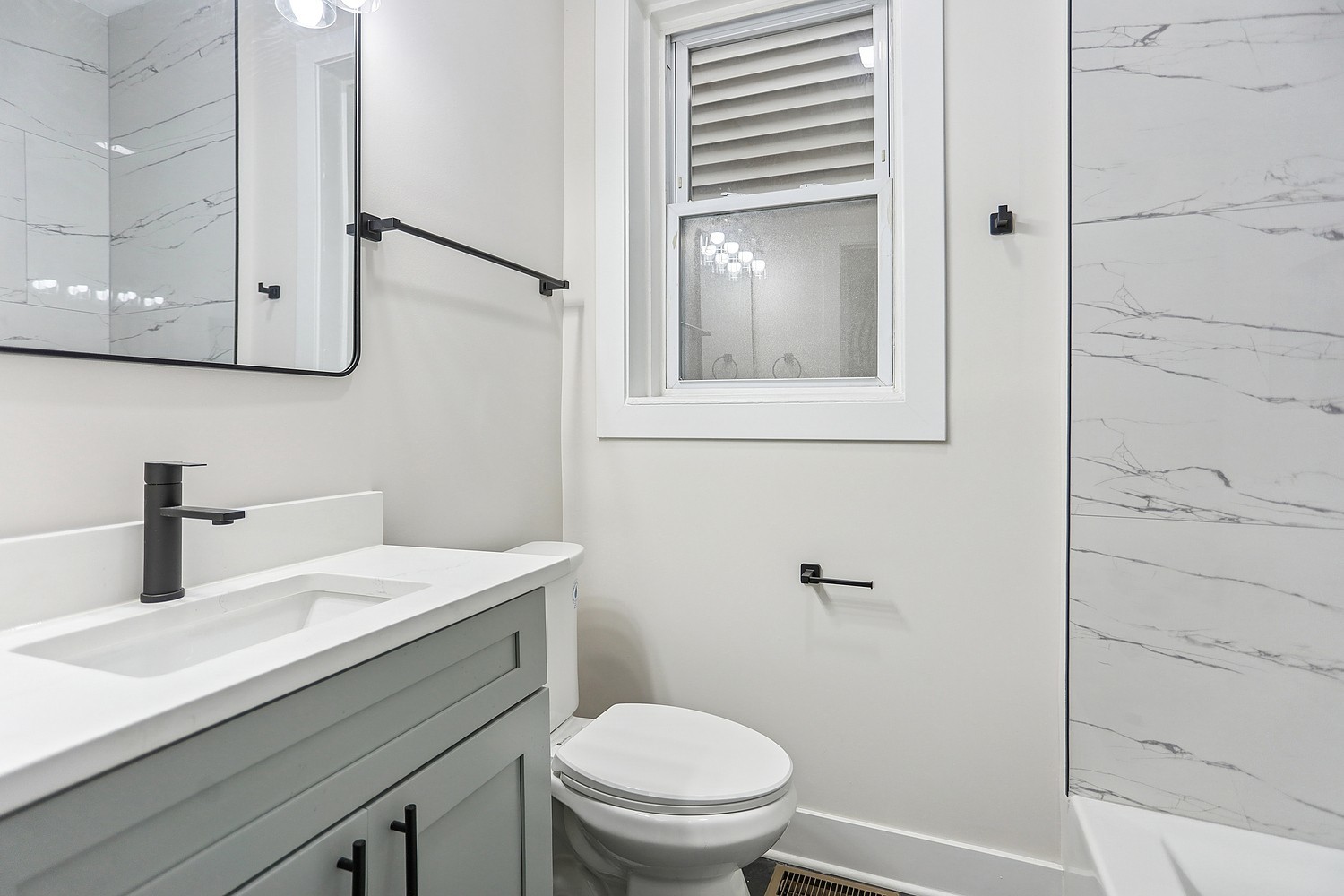 4832 West Harrison Street Chicago, IL 60644 - Photo 18 of 21 a bathroom with a toilet sink and mirror