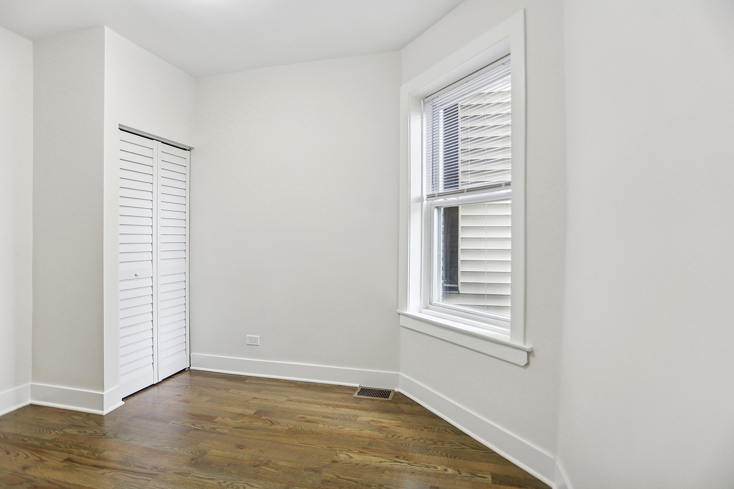 4832 West Harrison Street Chicago, IL 60644 - Photo 19 of 21 a view of an empty room with wooden floor and a window