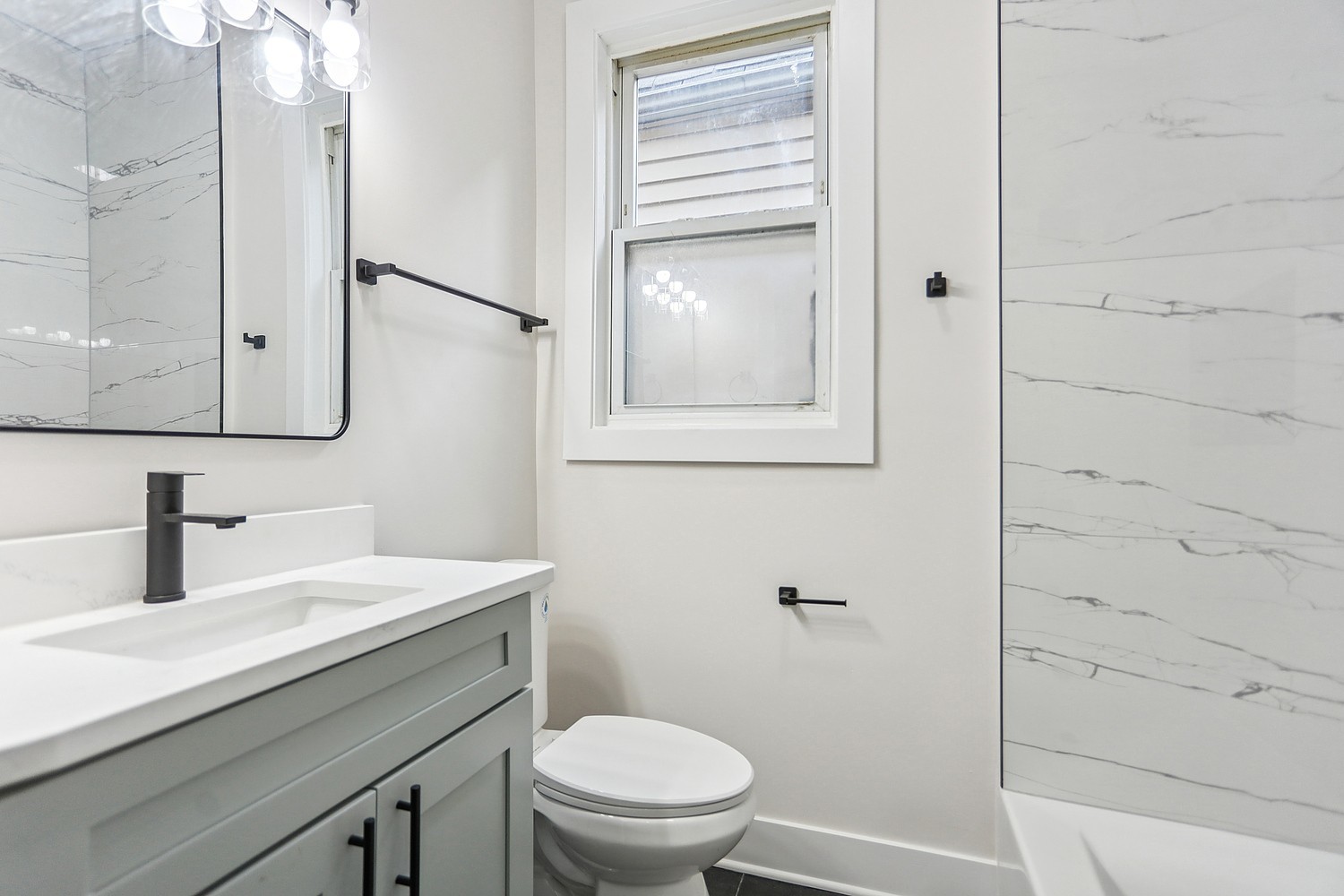 4832 West Harrison Street Chicago, IL 60644 - Photo 7 of 21 a bathroom with a sink a toilet and shower