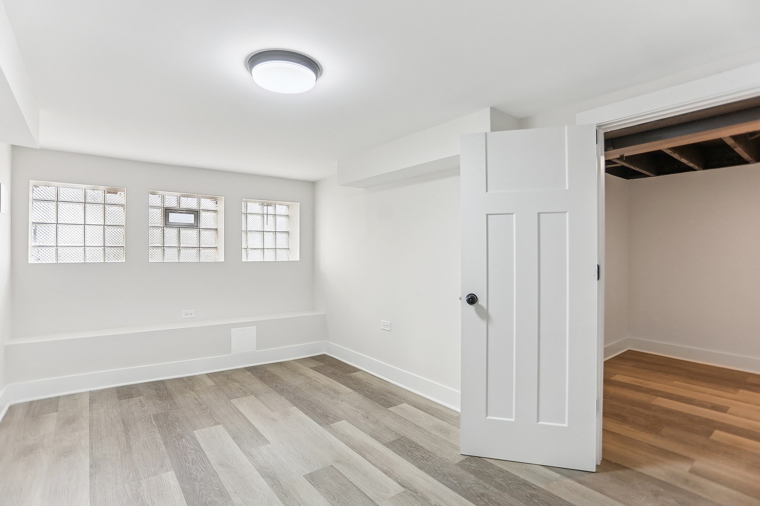 4832 West Harrison Street Chicago, IL 60644 - Photo 10 of 21 a view of an empty room with wooden floor and a window
