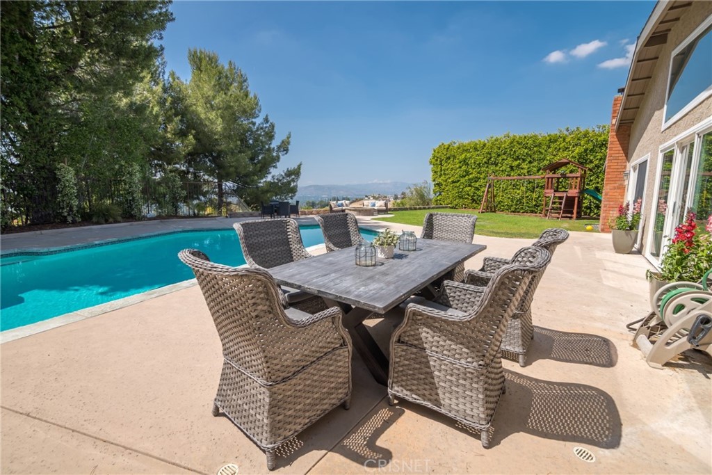 a backyard of a house with table and chairs