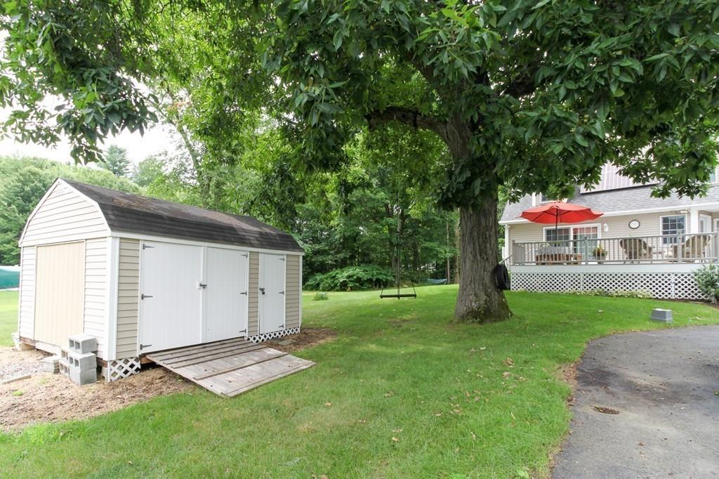 871 Northfield Road Lunenburg, MA 01462 - Photo 5 of 39 a view of backyard with a barn and large trees