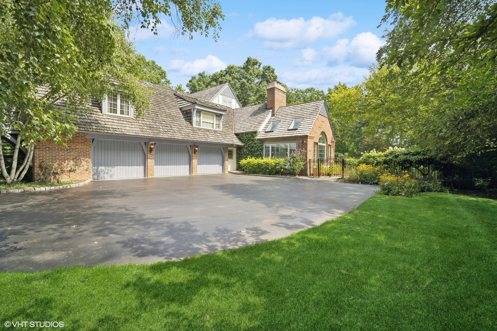 1214 Turicum Road Lake Forest, IL 60045 - Photo 2 of 37 a front view of a house with a yard and garage