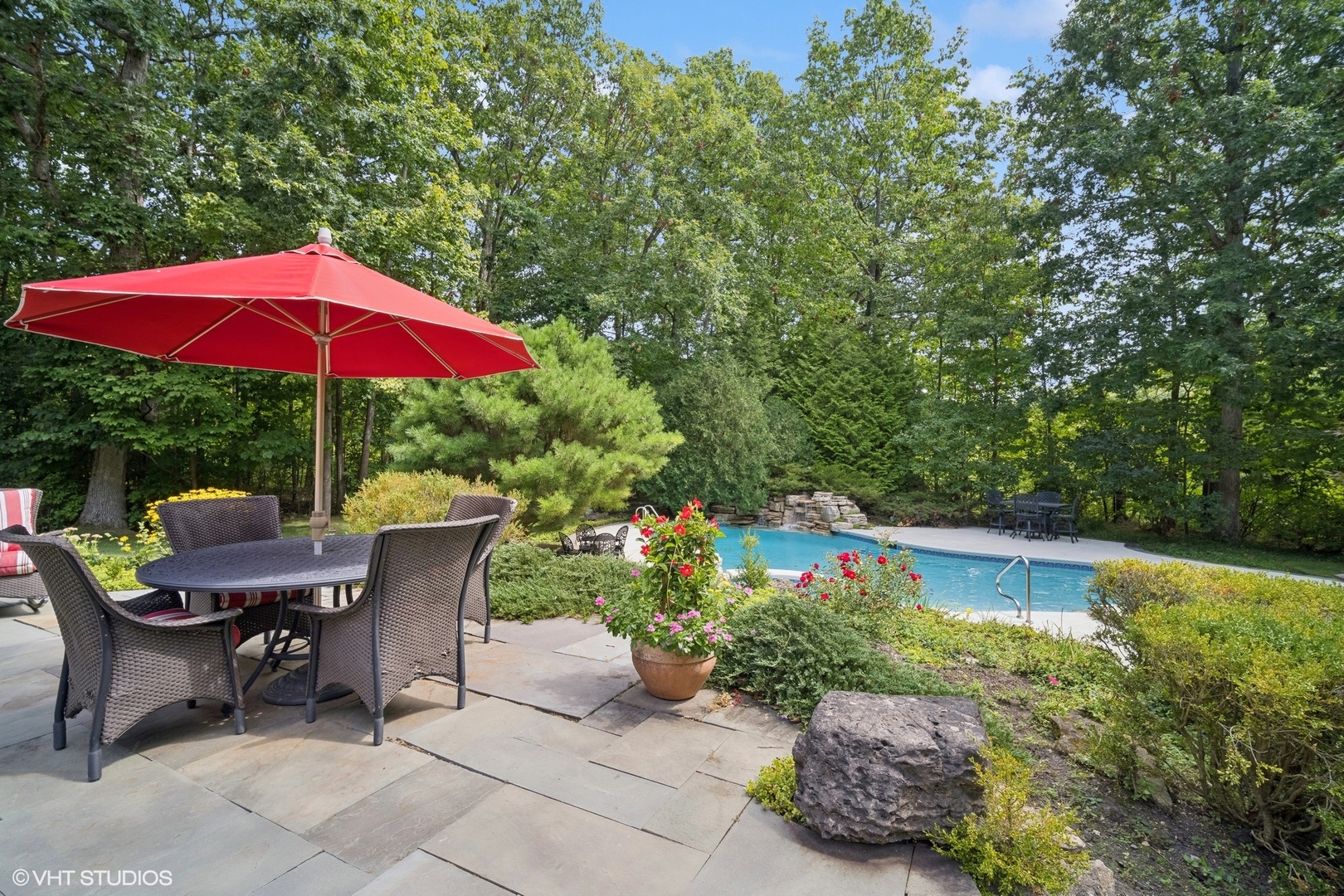1214 Turicum Road Lake Forest, IL 60045 - Photo 28 of 37 a view of a table and chairs under an umbrella in backyard