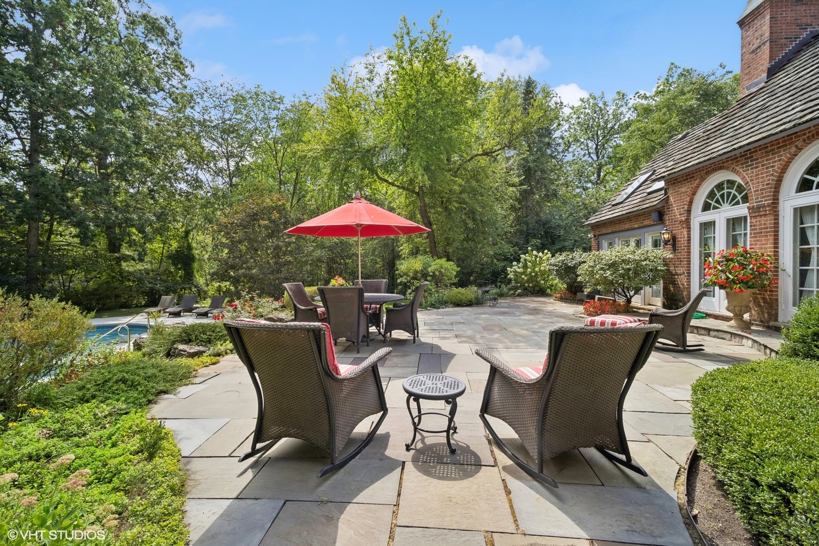 1214 Turicum Road Lake Forest, IL 60045 - Photo 29 of 37 a view of a patio with furniture and a table and chairs under an umbrella