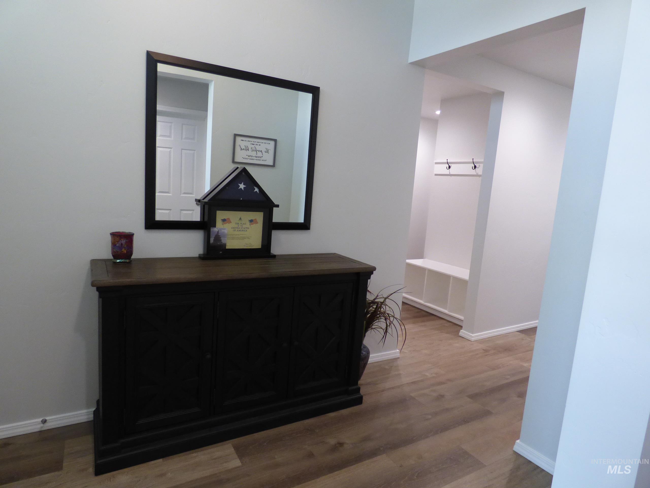 2708 East Buckaroo Drive Kuna, ID 83634 - Photo 32 of 48 Wood-finish flooring extending throughout the entryway and into an alcove featuring a built-in bench with storage cubbies and wall-mounted coat hooks